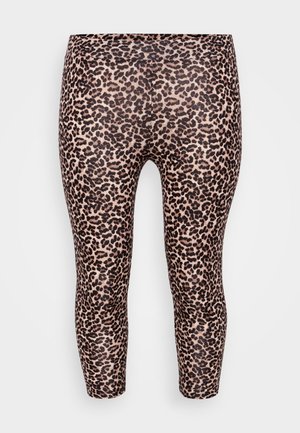 Leopard print leggings with a fitted design, elastic waistband, smooth texture, and a light beige background featuring dark brown spots.