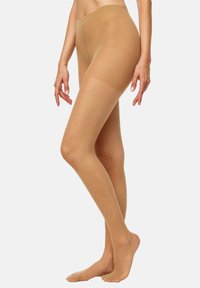 Pantys desnudas transparentes con una textura suave, cintura alta y punta reforzada. Ofrecen una apariencia natural y una cobertura uniforme del tono de piel.
