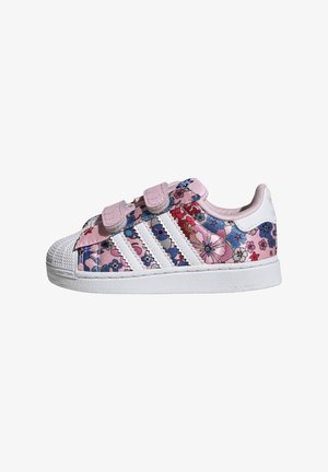 Pink fabric sneaker with floral pattern, white rubber toe cap, and three white stripes on the side. Features Velcro straps.