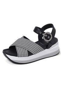 Sandali platform bianco e nero con tomaia intrecciata, design incrociato, cinturino alla caviglia regolabile e dettaglio decorativo in hardware circolare.