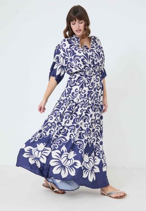 Maxi dress made of lightweight fabric, featuring a navy background with white floral and swirl patterns, cinched waist, and short sleeves.