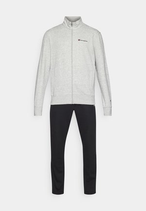 Gray fleece zip-up jacket with high collar and red logo, paired with black tapered sweatpants. Simple design, soft texture.