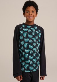 Dlhý rukáv košele s čiernym telom a tyrkysovým grafickým dizajnom, ktorý obsahuje slová "SALTY" a "DOG" v opakujúcom sa hexagonálnom vzore.