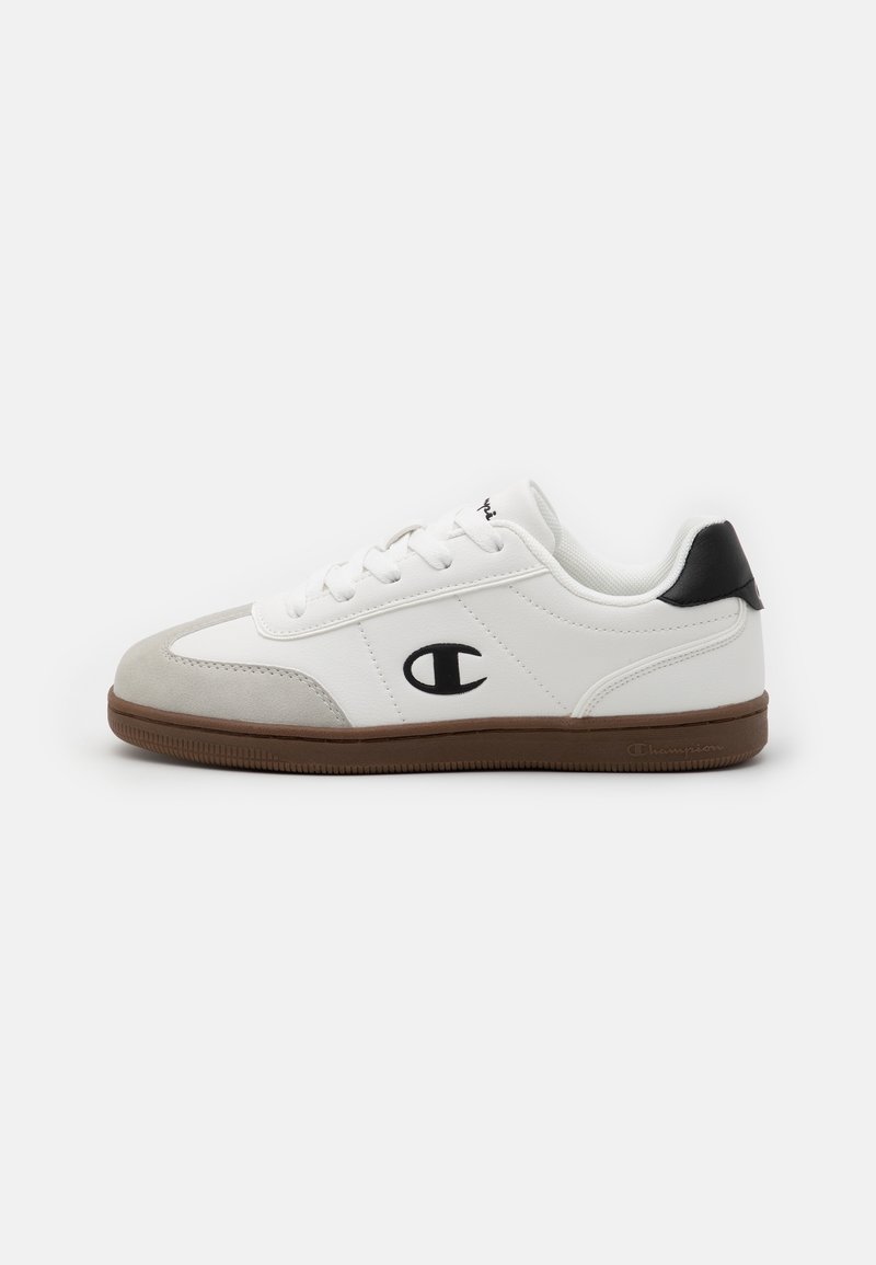 White sneaker with grey suede toe cap, black heel accent, rubber sole, and embroidered logo on the side. Classic athletic design.