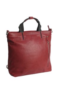 Red leather tote bag with dual top handles, zippered side pocket, smooth texture, and structured rectangular shape.