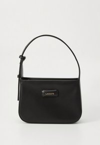 Čierna kožená kabelka s hladkou textúrou, obdĺžnikovým tvarom, jednou hornou rúčkou a zlatou logovou plaketou na prednej strane. Jednoduchý dizajn.