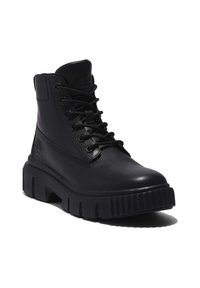 Black leather ankle boot with a chunky sole, round toe, and lace-up closure. Features a logo on the tongue and seamless side panel.