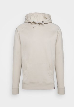Sweat à capuche beige de type pullover avec poche kangourou à l'avant et cordon blanc sur la capuche, affiché sur fond uni.