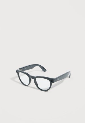 Occhiali Ray-Ban neri con montatura completa, lenti rotonde trasparenti e logo discreto sulla stanghetta, esposti su sfondo bianco.