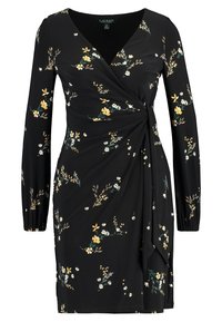 Svart omlottklänning med långa ärmar, som har ett blommönster i gult, vitt och grönt. Tillverkad av mjukt material med en rynkad midjedetalj.