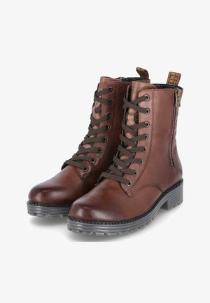 Bottines en cuir marron avec un système de laçage à l'avant, fermeture éclair sur le côté, bout rond et semelle en caoutchouc à motif. Agrémentées d'une étiquette logo sur le talon.