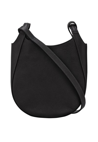 Black leather crossbody bag with a smooth texture, rounded shape, narrow adjustable strap, and minimalistic design.