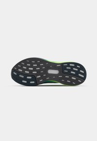 Semelle de chaussure avec une base en caoutchouc noir, un motif texturé avec des accents gris clair et des détails verts le long des bords.