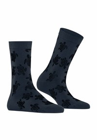 Calzettoni in cotone blu navy con un motivo di tartarughe nere a trama, di lunghezza media fino al polpaccio, con un bordo a coste per maggiore comfort e vestibilità.