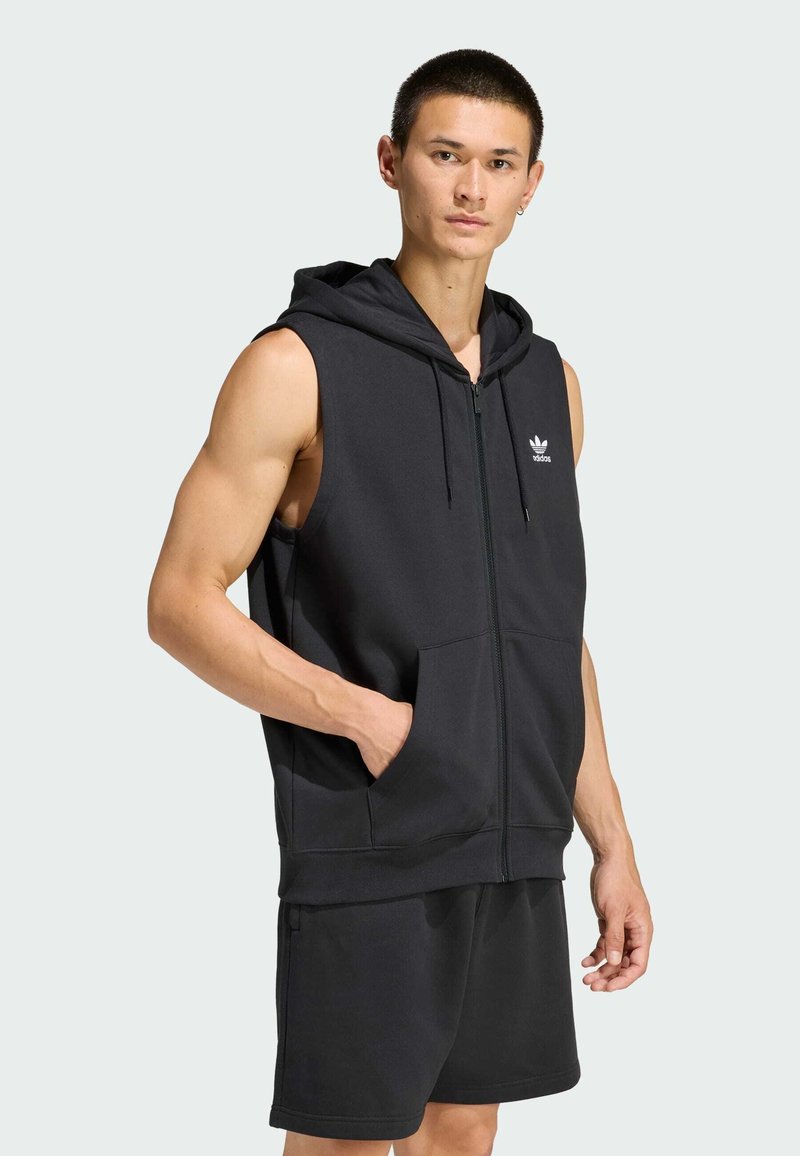 Black sleeveless hoodie made from soft fabric, featuring a zip front, two side pockets, and a small white logo on the chest.
