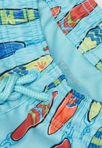 Blue swim shorts featuring a colorful surfboard pattern, elastic waistband with drawstring, and smooth, lightweight material.