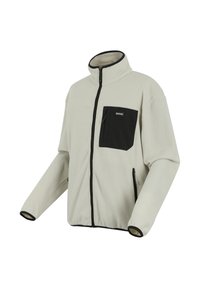 Light beige fleece jacket with black full front zipper, black chest pocket, and black trim on collar and cuffs.