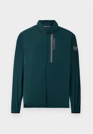 Dark green, lightweight zip-up jacket with a collared neck and a pocket on the chest, featuring a logo on the sleeve and sleek design lines.