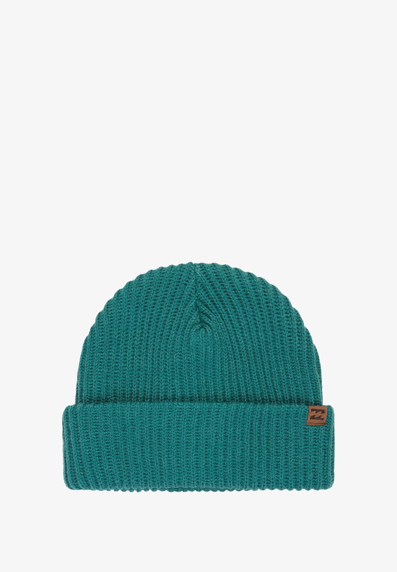 Teal knit beanie with a ribbed texture, featuring a rolled cuff and a small brown brand tag on the side.