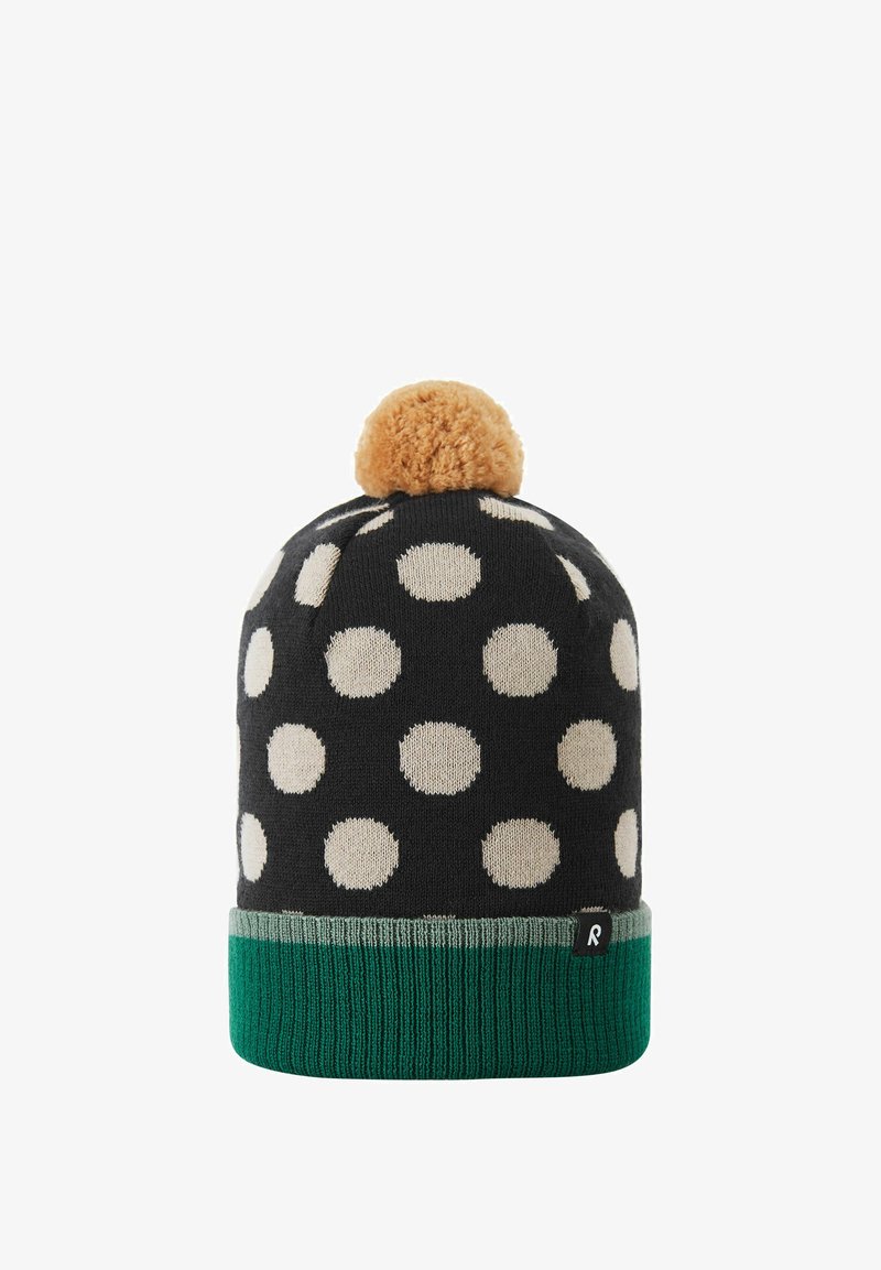 Black knitted beanie with white polka dots, green ribbed band, topped with a tan pom-pom. Material appears soft and textured.