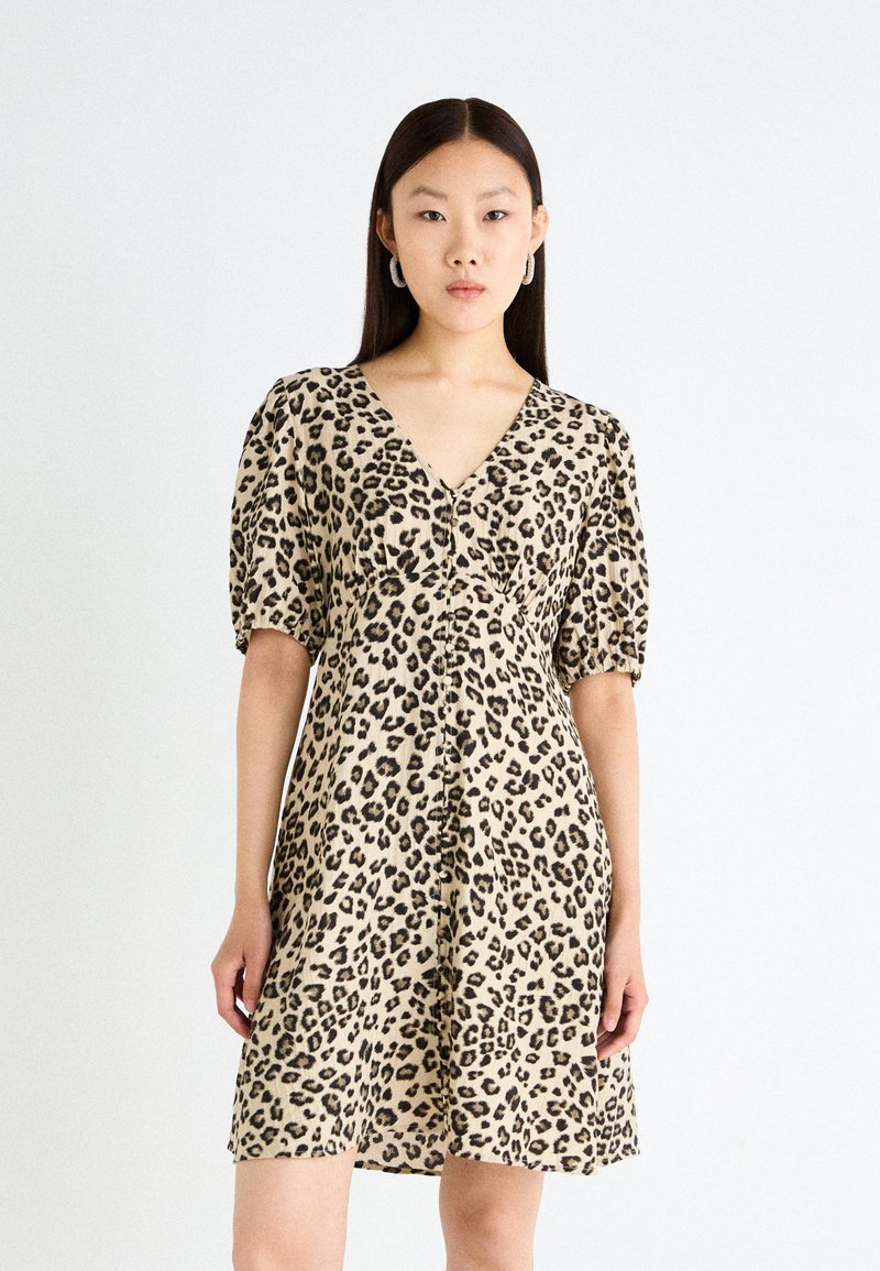 Leopard print dress made of lightweight fabric, featuring short puff sleeves, a V-neckline, and a flared silhouette.