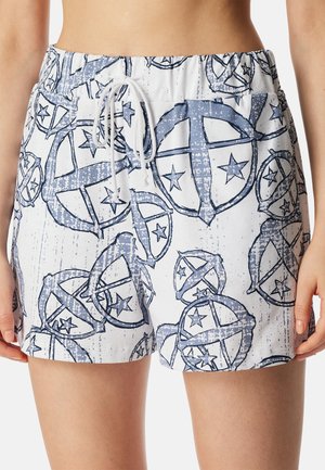 Korta simshorts i vitt med ett blått abstrakt stjärn- och cirkelmönster. De har en elastisk midja med snörning.