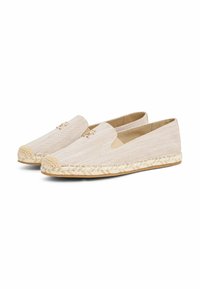 Espadrille-stijl schoenen in lichtbeige stof, met een jute geweven zool, instapontwerp en een subtiel metallic logo aan de voorkant.