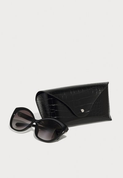 Black cat-eye sunglasses with gradient lenses next to a black, textured faux-crocodile case featuring a snap closure.