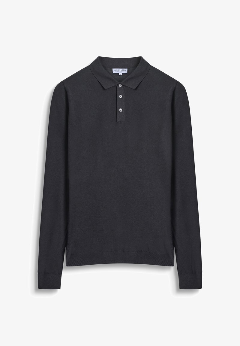 Crna polo majica dugih rukava s ovratnikom, tri gumbića sprijeda i rebrastim manžetama. Napravljena od glatkog, laganog materijala.