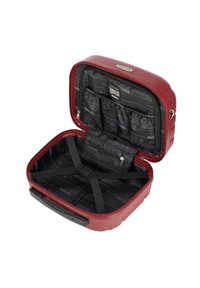 Valigia rigida rossa con un esterno testurizzato, dotata di un interno nero. Include cinghie elastiche e tasche per un'organizzazione ottimale.