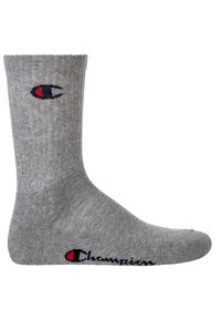 Gray cotton sock with ribbed texture, featuring a small Champion logo in navy and red on the ankle. Standard crew length.