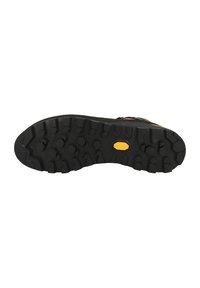Sole di scarpa da trekking nera con scanalature profonde, con logo giallo Vibram per la trazione. Superficie lievemente testurizzata e design robusto.
