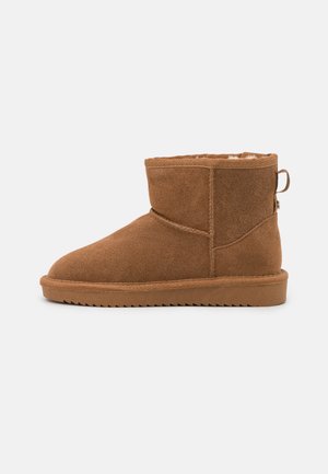 Brown suede ankle boots with a plush interior lining, rounded toe, flat rubber sole, and a rear pull tab for easy wear.