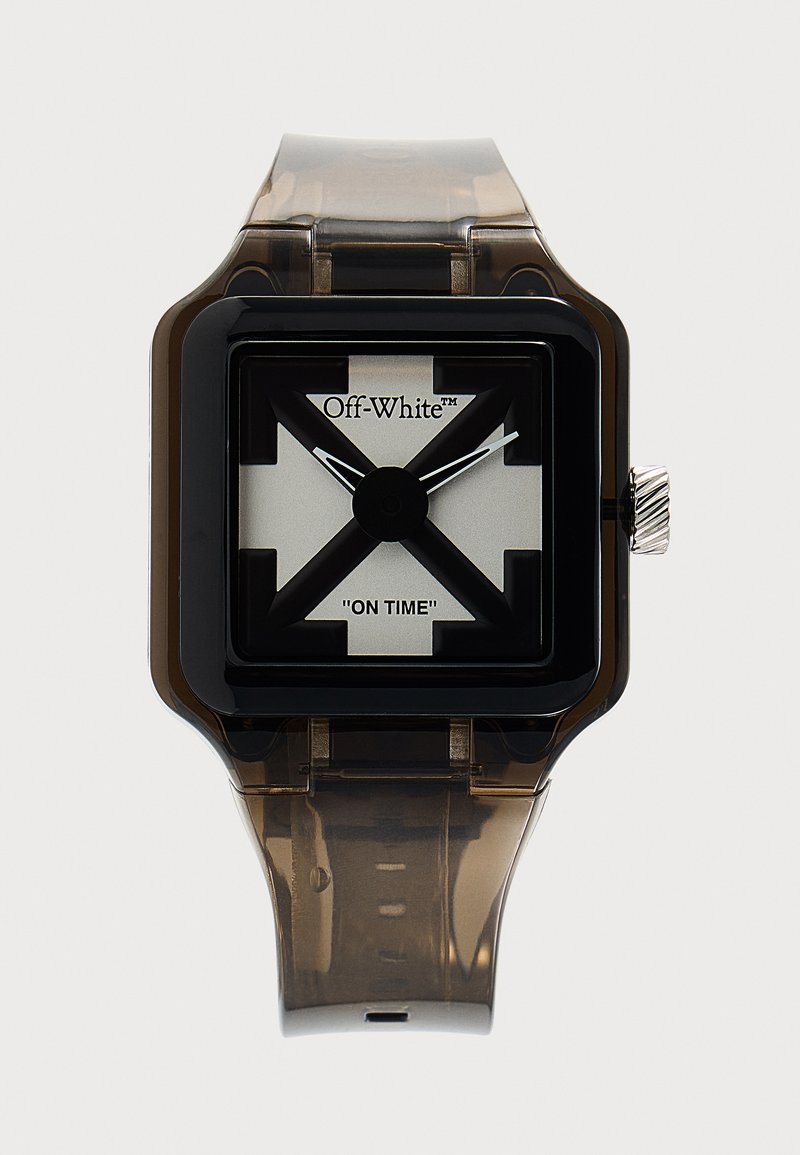 Montre carrée noire et argentée avec bracelet translucide brun fumé, aiguilles noires sur le cadran, logo "Off-White" et texte "ON TIME" sur le cadran.