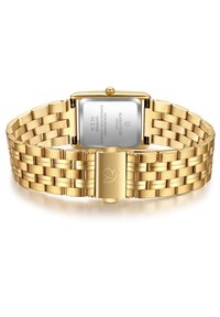 Zelts, nerūsējošā tērauda pulkstenis ar taisnstūra korpusu, teksturētu aproci, aizdares ar sirds logotipu un spīdīgu apdari aizmugurē.