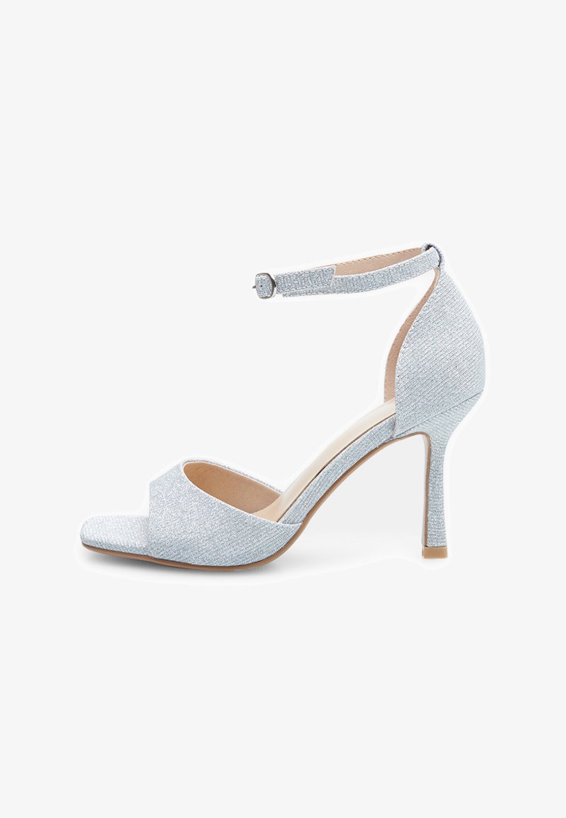 Silver glitter heeled sandal featuring an open toe, ankle strap with buckle, and a slim high heel. Smooth interior with a textured upper.