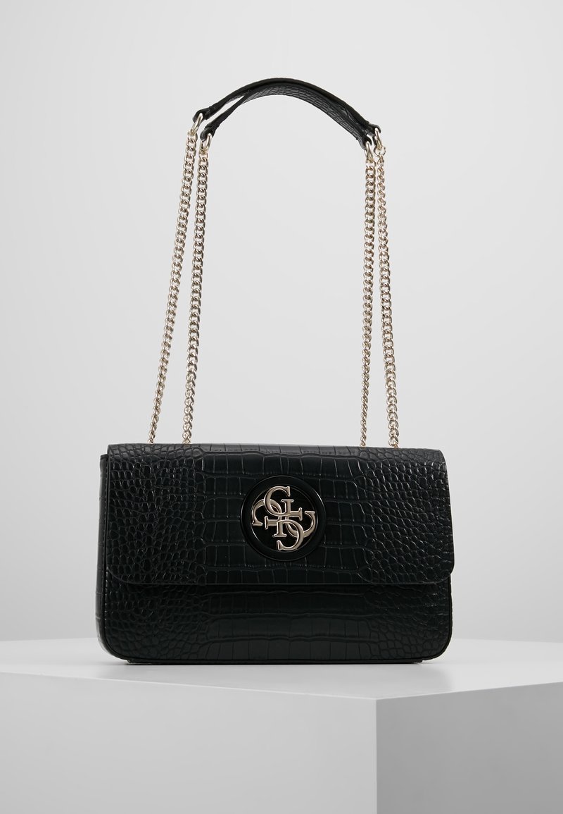 Černá kabelka z umělé krokodýlí kůže s klopou a zlatým kováním. Má řetízkový popruh a kruhový akcent s logem.