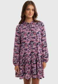 Floral dress featuring pink and white leaf patterns on a navy background, long sleeves, a gathered skirt, and a buttoned neckline.