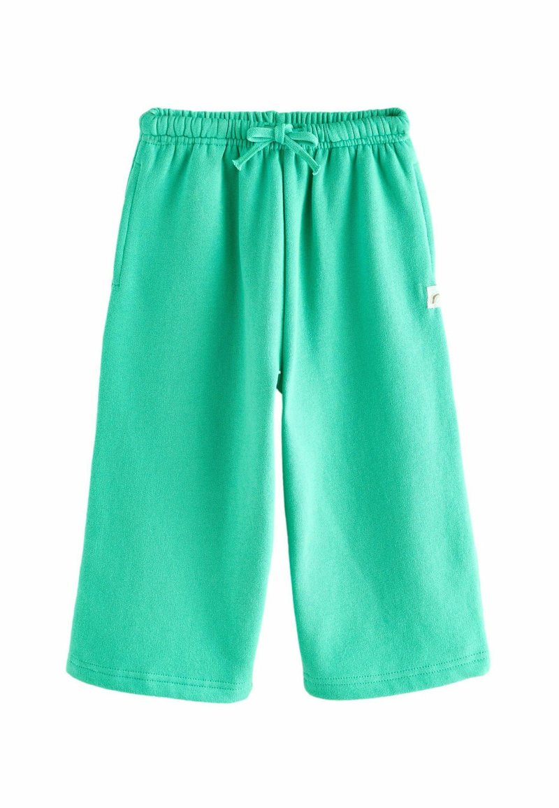 Shorts en sweat turquoise en tissu doux, avec une taille élastique à cordon de serrage et des poches latérales pour plus de fonctionnalité.