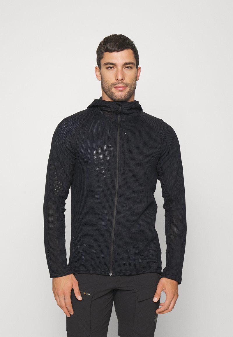 Hoodie noir zippé avec un design en maille texturée, doté d'une capuche et de manches longues. Le matériau semble léger et respirant.
