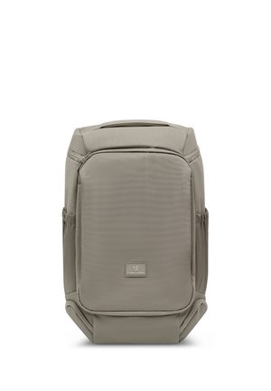 Rectangular gray backpack with front zippered pocket, side pockets, top handle, and a small logo patch reading Johnny Urban.