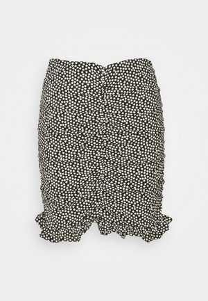 Zwarte rok met een wit gespikkeld patroon, voorzien van een gerimpelde zoom en een getextureerd oppervlak. Ontworpen met geplooide details langs de zijkanten.