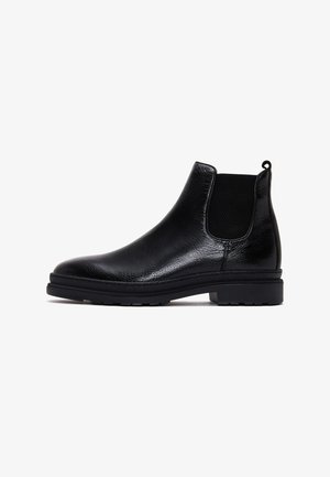 Bottines Chelsea en cuir noir avec des panneaux latéraux en élasthanne, finition texturée, languette à l'arrière et semelle en caoutchouc robuste.