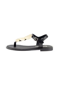 Sandalia plana negra con diseño de separador de dedos, correa adjustable para el tobillo y tres acentos circulares dorados texturizados en la parte superior.