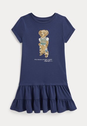 Tengerészkék rövid ujjú ruha fodros szegéllyel és mintával, amely egy foltozott nadrágot és pulóvermellényt viselő medvét ábrázol.