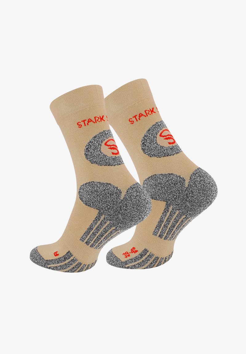 Chaussettes beiges avec un bord texturé gris, présentant un motif noir et rouge et un poignet côtelé. Taille 39-42 indiquée sur la semelle.