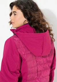 Fuchsia jacket featuring a mix of smooth and quilted textures, with a hood and zip closure. The back showcases a padded design.