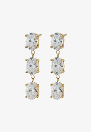 Zelta krāsas piekariņu auskariem ir trīs ovālas, fasētas caurspīdīgas akmeņi ķermeņa izgatavotiem turētājiem, savienoti ar metāla posmiem, demonstrējot pulētu apdari.