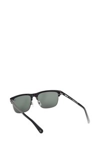 Černé sluneční brýle s polovičním rámem a tmavozelenými skly, nastavitelnými nosními podložkami a tenkými stranami s logem Timberland na pravém spánku.