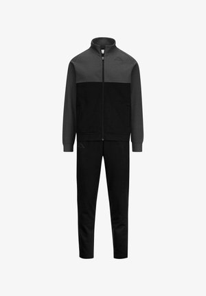 Tuta sportiva con giacca con zip in grigio scuro e nero, dotata di tasche laterali e pantaloni neri coordinati; realizzata in tessuto morbido.